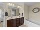This bathroom features a double sink vanity, lots of storage, and a soaking tub at 189 Grey Hawk Dr, Garner, NC 27529