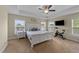 Bright bedroom features tray ceilings, neutral colors, and large windows providing ample natural light at 189 Grey Hawk Dr, Garner, NC 27529