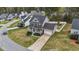 Aerial view of a charming two-story home with well-maintained landscaping, driveway, and fenced backyard at 189 Grey Hawk Dr, Garner, NC 27529