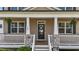 Charming front porch features classic columns, stone accents, and a welcoming entrance with green landscaping at 189 Grey Hawk Dr, Garner, NC 27529