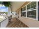 Spacious covered front porch with wood flooring, white columns, and a view of the neighborhood at 189 Grey Hawk Dr, Garner, NC 27529