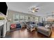 Open living room with a large sectional sofa, hardwood floors, and a ceiling fan at 189 Grey Hawk Dr, Garner, NC 27529