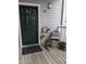 Charming front porch with potted plants, a black door, and a welcoming atmosphere at 1911 Wolftech Ln # 204, Raleigh, NC 27603
