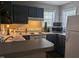 Bright kitchen featuring a white range, microwave, and neutral countertops at 1911 Wolftech Ln # 204, Raleigh, NC 27603