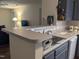 Contemporary kitchen features a sink, and open view into the living area at 1911 Wolftech Ln # 204, Raleigh, NC 27603
