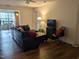 Cozy living room with hardwood floors, leather sectional, and sunroom view at 1911 Wolftech Ln # 204, Raleigh, NC 27603