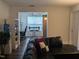Relaxing living room with a view to a dining area and a comfortable black sofa at 1911 Wolftech Ln # 204, Raleigh, NC 27603