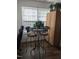 Bright sunroom with an antique table, stools and view of the backyard at 1911 Wolftech Ln # 204, Raleigh, NC 27603