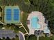 Aerial view of community pool, tennis courts, parking and clubhouse surrounded by mature trees at 192 Solheim Ln, Raleigh, NC 27603