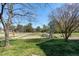 Backyard view of community walking path and playground with mature shade trees at 192 Solheim Ln, Raleigh, NC 27603
