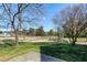 Backyard view of community walking path and playground with mature shade trees at 192 Solheim Ln, Raleigh, NC 27603