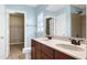 Well-lit bathroom with double sinks, a shower, and a walk-in closet at 192 Solheim Ln, Raleigh, NC 27603