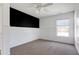 Bright bedroom with paneled walls, neutral carpet, and a large window at 192 Solheim Ln, Raleigh, NC 27603
