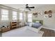 Cozy ' bedroom with neutral walls, playful decor, a desk, and ample natural light from multiple windows at 192 Solheim Ln, Raleigh, NC 27603