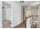 Bright hallway features hardwood floors and access to multiple bedrooms and a stairway at 192 Solheim Ln, Raleigh, NC 27603