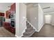 Hallway with access to the kitchen and a carpeted staircase to the upper level at 192 Solheim Ln, Raleigh, NC 27603