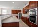 Gourmet kitchen with stainless steel appliances and custom cabinetry at 192 Solheim Ln, Raleigh, NC 27603