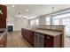 Spacious kitchen features wood cabinets, stainless steel appliances and a view to the backyard patio at 192 Solheim Ln, Raleigh, NC 27603