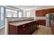 Bright kitchen features stainless steel appliances, wood cabinets and an island with countertop seating at 192 Solheim Ln, Raleigh, NC 27603