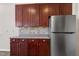 Beautiful kitchen features wood cabinets, backsplash, countertops and stainless steel refrigerator at 192 Solheim Ln, Raleigh, NC 27603