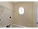 Neutral laundry room features a shelf, circular window, and hookups ready for washer and dryer at 192 Solheim Ln, Raleigh, NC 27603