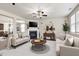 Spacious living room features plush sofas, a fireplace, ceiling fan, and large windows for natural light at 192 Solheim Ln, Raleigh, NC 27603
