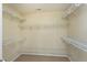 Walk-in closet featuring white wire shelving and neutral-colored carpeting at 192 Solheim Ln, Raleigh, NC 27603