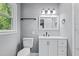 Well-lit bathroom with stylish vanity, modern fixtures, and toilet next to a window at 204 N Gurney St, Burlington, NC 27215