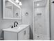 Modern bathroom featuring white vanity, updated fixtures, and tiled walk-in shower at 204 N Gurney St, Burlington, NC 27215