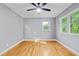 Spacious bedroom featuring hardwood floors, neutral walls, and abundant natural light from two windows at 204 N Gurney St, Burlington, NC 27215
