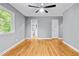 Bedroom with hardwood floors, natural light, and an en suite bathroom visible through doorway at 204 N Gurney St, Burlington, NC 27215