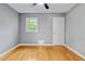 The bedroom boasts hardwood floors, a modern ceiling fan, and a window for natural light at 204 N Gurney St, Burlington, NC 27215