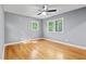 Bright bedroom with neutral walls, hardwood floors, and dual windows providing ample natural light at 204 N Gurney St, Burlington, NC 27215