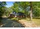 Charming two-story home with brick accents, blue siding, mature trees and a long concrete driveway at 204 N Gurney St, Burlington, NC 27215