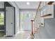 Light-filled foyer featuring new flooring, fresh gray paint, and stairs to the second floor at 204 N Gurney St, Burlington, NC 27215