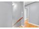 Hallway featuring grey walls and a light-stained wood railing leading towards a room at 204 N Gurney St, Burlington, NC 27215