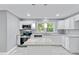 Modern kitchen boasts white cabinets, granite countertops, and stainless steel appliances, a chef's delight at 204 N Gurney St, Burlington, NC 27215