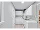 Functional laundry room with ample storage, white cabinetry, and a convenient sink, making chores a breeze at 204 N Gurney St, Burlington, NC 27215