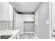 Efficient laundry room offering extra storage cabinets and a sink, designed for convenience and functionality at 204 N Gurney St, Burlington, NC 27215