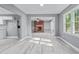 Open-concept living room features a cozy brick fireplace and access to the kitchen and dining area at 204 N Gurney St, Burlington, NC 27215