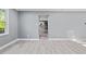 Bright living room featuring new floors, gray paint and an open floor plan to kitchen and dining area at 204 N Gurney St, Burlington, NC 27215
