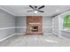 Charming living room boasts a brick fireplace, ceiling fan, and neutral tones, creating a comfortable atmosphere at 204 N Gurney St, Burlington, NC 27215