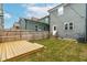 Cozy backyard with deck, privacy fence, string lights, and small lawn at 221 Douglas Falls Dr, Wendell, NC 27591