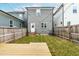 Backyard featuring a wood deck, fence, string lights, and manicured lawn at 221 Douglas Falls Dr, Wendell, NC 27591