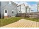 Backyard with a wooden deck, privacy fence, and string lights at 221 Douglas Falls Dr, Wendell, NC 27591
