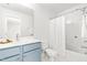 Bathroom with light blue vanity, tub with shower, and coordinated decor at 221 Douglas Falls Dr, Wendell, NC 27591