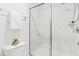 Bathroom with modern marbled tile shower, glass door, and sleek fixtures at 221 Douglas Falls Dr, Wendell, NC 27591