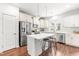 Modern kitchen with white cabinets, stainless steel appliances, and a center island with seating at 221 Douglas Falls Dr, Wendell, NC 27591