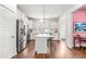 Bright kitchen features stainless steel appliances, a center island, and ample white cabinetry at 221 Douglas Falls Dr, Wendell, NC 27591