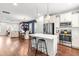 Open-concept kitchen features white cabinets, stainless appliances, and a center island with bar seating at 221 Douglas Falls Dr, Wendell, NC 27591